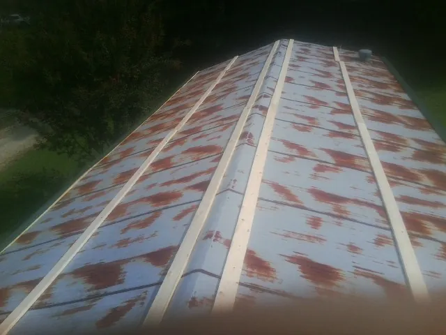 Rusted metal roof panels with new wood purlins before replacement — Storm Damage Roof Repair in Galloway by Roofing Brothers