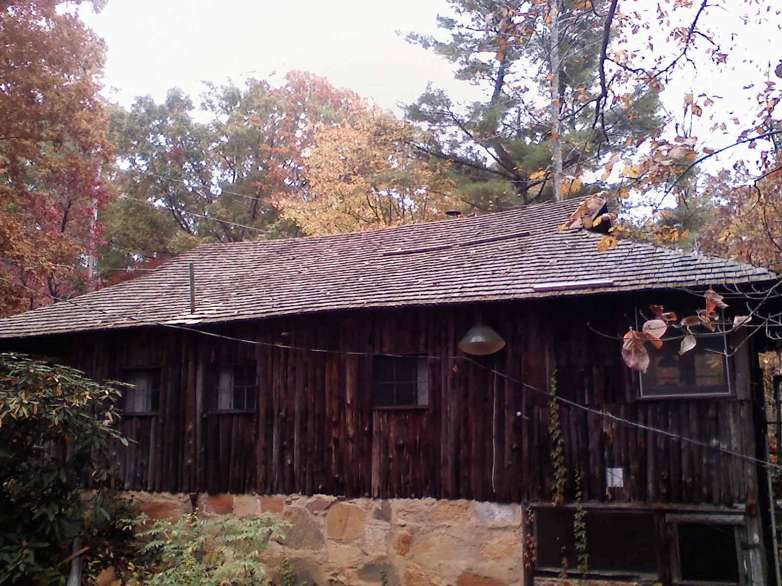 Weathered wood shake roof on a rustic board sided cabin in Galloway