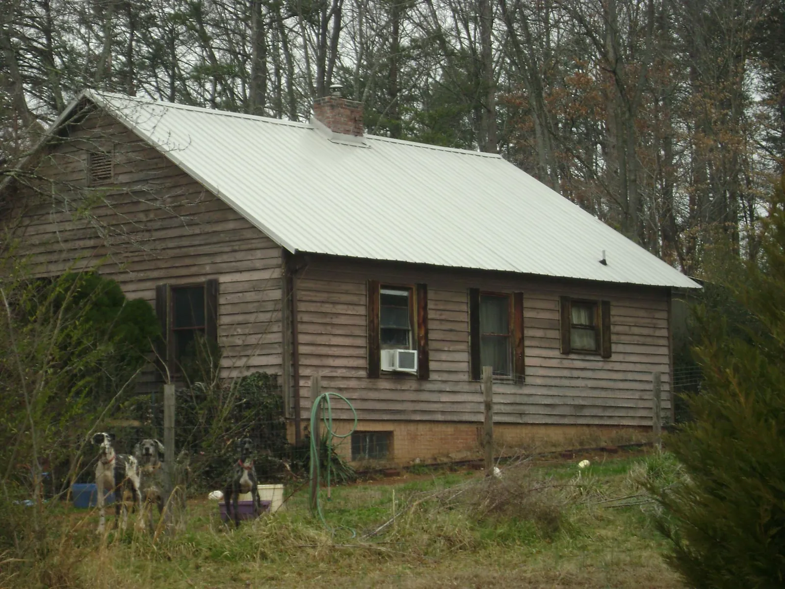 White metal roof on an old wood sided farmhouse, from a Asphalt Shingle Roof Repair job in Galloway